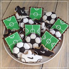 decorated cookies in the shape of soccer balls and shoes