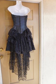 "Vintage small size P black dress with leather sweetheart bodice and ruffle lace layered skirt. Zips up the back. In great vintage condition! Measurements taken across front laid flat 15\" across front armpit to armpit 12\" across front of waist -doubles to 24\" 17\" across front of hips 27\" length armpit to bottm" Formal Black Corset Dress With Corset Back, Evening Corset Dress With Lace Patchwork, Evening Lace Patchwork Fitted Corset Dress, Formal Black Corset Back Dress, Formal Black Corset Dress, Black Fitted Corset Dress With Ruffles, Formal Lace Overbust Corset Dress, Black Lace Corset For Party, Black Overbust Corset Dress For Formal Occasions