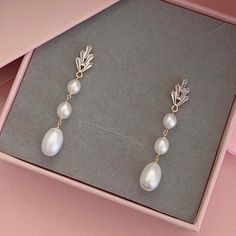 * DETAILS * - Freshwater Pearls - Gold Plated Cubic Zirconia Paved Leaf Ear post 15*8mm (Sterling Silver pin) 🎁A designer pull drawer pink gift box is available when the gift wrapping option is chosen. ✨WHITE GOLD earrings are available. https://www.etsy.com/JinnysJewelryBySeJin/listing/1291225865/freshwater-pearl-droplets-earrings?utm_source=Copy&utm_medium=ListingManager&utm_campaign=Share&utm_term=so.lmsm&share_time=1676756725062 🌟More earrings. https://www.etsy.com/JinnysJewelryBySeJin/lis Pearl White Cubic Zirconia Dangle Earrings, White Plated Pearl Earrings For Wedding, Wedding Drop Pearl Earrings With Plating, Silver-plated Pearl Earrings For Wedding, Silver Plated Pearl Earrings For Wedding, Dainty Wedding Earrings With Plating, Bridal Earring, Droplet Earrings, Pink Gift Box