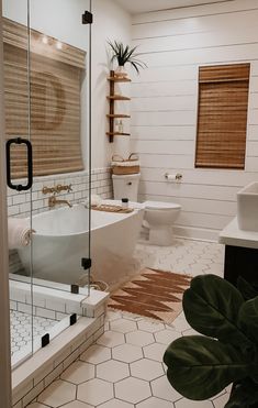 a bathroom with a tub, toilet and sink in it's own area is shown