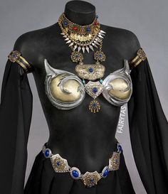 a woman's costume with gold and blue jewels