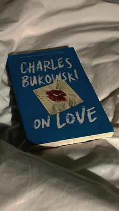 the book charles bukowski on love is laying on a bed