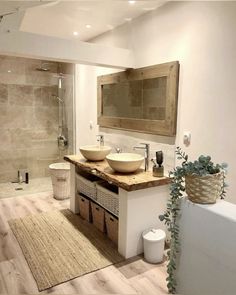 a bathroom with two sinks and a large mirror on the wall next to a bathtub