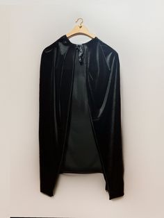 a black jacket hanging up on a hanger