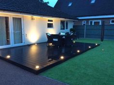 an outdoor deck lit up with lights