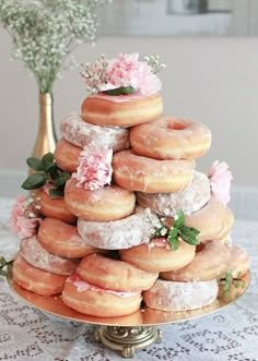 a large stack of doughnuts sitting on top of a table