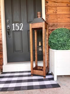 a wooden lantern sitting on top of a black and white checkered floor next to a door