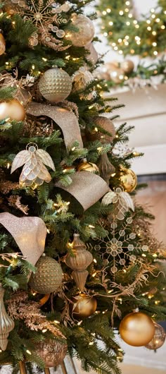 a christmas tree decorated with gold and silver ornaments