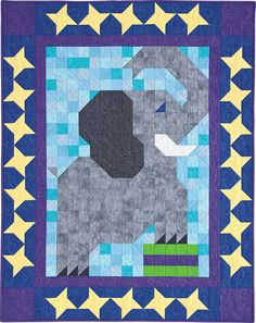 an elephant with stars around it on a blue and yellow quilted wall hanging ornament