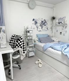 a bedroom with a bed, desk, and chair in it's white color scheme