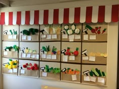 the wall is filled with lots of different fruits and vegetables that are on display in boxes