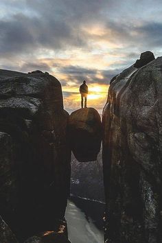 a person standing on top of a cliff