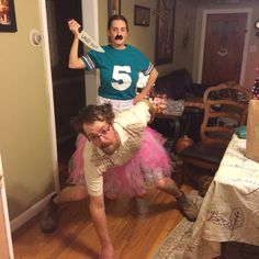 two people dressed up in costumes and one is on the floor with his leg over another person's head