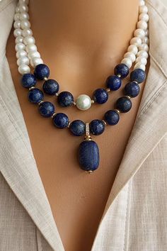 A timeless accessory that embodies natural beauty, our elegant Pearl and Lapis Lazuli Necklace combines lustrous freshwater pearls, known for their lustrous and iridescent appeal, with the deep blue appeal of genuine Lapis Lazuli gemstones. Handmade with love and attention to detail, this stunning necklace exudes a sense of opulence and elegance. Elegant Single Strand Beaded Necklace, Elegant Gold Beaded Necklace With Gemstone Accents, Elegant Double Strand Gemstone Beads Necklaces, Double Strand Pearl Necklace With Natural Stones, Spiritual Pearl Jewelry With Gemstone, Fine Jewelry Sapphire Stones, Fine Jewelry With Sapphire Stones, Elegant Single Strand Blue Jewelry, Elegant Single Strand Crystal Necklace For Formal Occasions