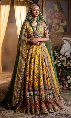 Pakistani Bridal Dress in Yellow Lehenga Choli Style is a classic masterpiece that will give the gorgeous bride a head-turning glamorous look on the most important day of your life. Lavish designs and embellishments give a perfect finishing to this stunning Bridal Lehenga Choli. Lehenga Choli: The choli is in an alluring yellow color is gracefully embellished with intricate designs, zardosi, sequins, tilla, and Resham. Shimmering ornaments, hanging motifs, and lavish contrast of colors make this choli a perfect choice to pair with the Bridal Lehenga. Bridal Lehenga: This Bridal Lehenga is emblazoned with the intricate designs, dabka, tilla, kora, Resham work, sequins, and crystals. The Yellow Lehenga has a huge flare and is adorned with Shimmering details and floral designs, making this Pa Choli Style, Yellow Lehenga Choli, Bridal Lehenga Pakistani, Pakistani Bridal Lehenga, Pakistani Bridal Dress, Yellow Lehenga, Pakistani Wedding Dress, Glamorous Look, Pakistani Bridal Dresses