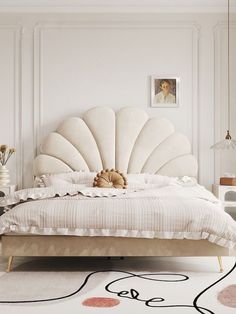 a white bed sitting in a bedroom on top of a rug