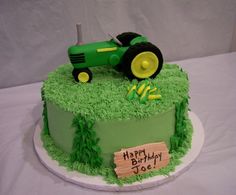 a green birthday cake with a tractor on it