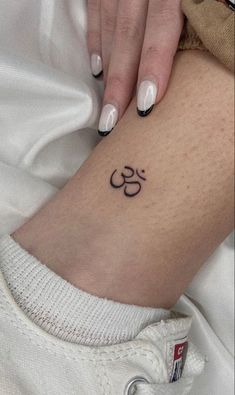 a woman's leg with a small tattoo on the lower part of her body