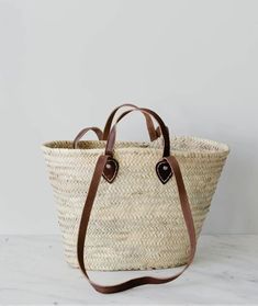 Pictured is a Double Dark Brown Handled  French Market Basket sold at The Hare & The Hart in downtown Thomasville, Georgia. Market Basket Bag, French Basket, French Market Basket, Moroccan Basket, Braided Bag, French Baskets, Storing Blankets, Natural Baskets, Knitted Bag