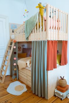 a child's bedroom with bunk beds and curtains