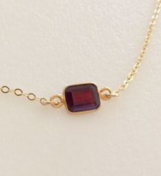 Lovely burgundy red natural garnet gemstone set in 24k gold vermeil bezel. Pendant is 6 x 8 mm and suspended from delicate sparkling 14k gold fill cable chain with matching spring ring clasp. Available in several lengths. Beautiful minimalist necklace makes lovely gift for a January birthday or Valentine sweetheart! Formal Burgundy Gemstone Jewelry, Dainty Garnet Gemstone Jewelry, Dainty Gold Garnet Jewelry, Gold Garnet Jewelry With Bezel Setting, Gold Garnet Jewelry With Gemstone Accents, Gold Garnet Gemstone Jewelry, Faceted Garnet Jewelry In Yellow Gold, Gold Jewelry With Garnet Birthstone, Gold Garnet Jewelry With Birthstone