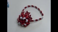 a red and white headband with polka dots on it, attached to a hair bow