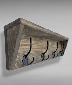 a wooden coat rack with hooks on it