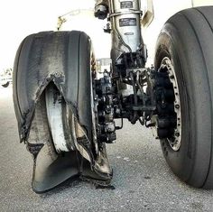 the front wheels and tires of a motorcycle that has been badly torn apart in an accident