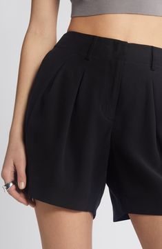 Inverted front pleats bring polished style to flowy shorts fashioned from lightweight twill in a high-waisted silhouette. 5" inseam; 24" leg opening; 10 1/2" front rise; 14" back rise (size 8) Zip fly with hook-and-bar closure Front slant pockets; back welt pockets 92% rayon, 8% polyester Machine wash, line dry Imported Elegant Pleated Shorts With Short Inseam, Elegant Black Shorts With Belt Loops, High Rise Black Shorts With Belt Loops, Pleated High-waisted Cotton Shorts, Black High-rise Cotton Shorts, Trouser Shorts, Polished Style, Flowy Shorts, High Waisted Trousers