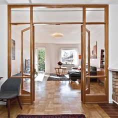 a living room filled with furniture and a fire place next to a doorway that leads to a patio