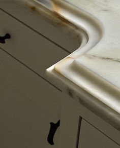 a kitchen counter top with two black handles