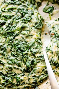 spinach and cheese dip in a bowl with a spoon