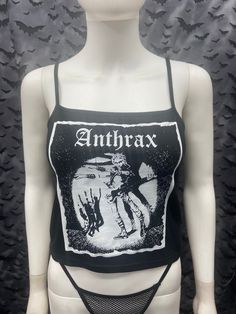 This is a black Anthrax crop tank top with spaghetti straps. This has a Anthrax image screen printed on the front. 57% cotton/ 38% polyester/ 5% Spandex These are handmade screenprinted and slightly vary from the photo. Please feel free to email me any questions. Thanks for looking. Due to an influx of incorrect addresses if a package is returned, you must pay the shipping cost to resend the item to you. The seller is not responsible for any lost or stolen packages. Black Sleeveless Emo Tank Top, Punk Crop Top For Festivals, Punk Style Crop Top For Festival, Punk Crop Top For Halloween, Gothic Cropped Top For Summer, Gothic Cropped Crop Top For Summer, Black Gothic Tank Top For Streetwear, Black Sleeveless Punk Crop Top, Punk Style Black Crop Top Tank