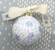 a blue and white ornament with a bow on it