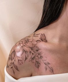 a woman with a flower tattoo on her shoulder