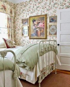 a bed room with a neatly made bed and pictures on the wall