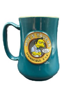 a blue coffee mug with the simpsons character on it's side, says more tavern springfield usa