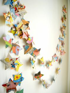 some colorful paper stars hanging on a wall