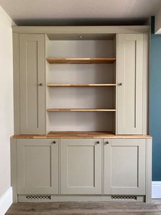 an empty room with some shelves and cupboards