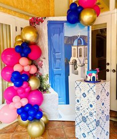 a bunch of balloons that are in front of a door