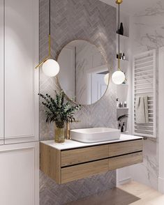 a bathroom with a sink, mirror and plant on the counter in front of it