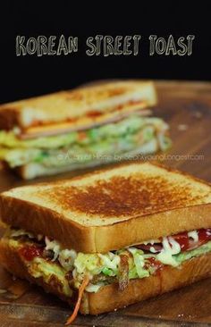 a close up of a grilled sandwich on a cutting board with the words korean street toast