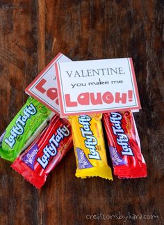 valentine's day candy bar wrappers are sitting on top of a wooden table