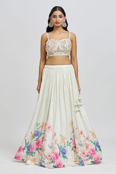 Ivory attached cancan lehenga with floral blossom print, accentuated with all over sequin embroidery. Paired with a padded blouse with all over embroidery using sequin, zari, nakshi and cutdana work and dupatta. - Aza Fashions Fitted Lehenga With Intricate Embroidery For Summer, Summer Lehenga With Intricate Embroidery, Elegant Floral Print Wedding Choli, Elegant Summer Wedding Lehenga, White Floral Print Dress For Reception, White Lehenga With Floral Embroidery For Party, Spring Fitted Lehenga With Intricate Embroidery, White Floral Embroidered Lehenga For Party, White Floral Print Choli For Reception