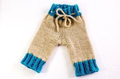 a knitted pair of pants with blue and beige stripes on the bottom, tied up