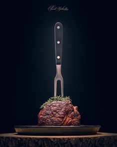 a steak on a plate with a knife stuck in it