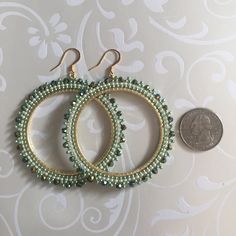 Extra Large Seed Bead Hoop Earringsp Hoop earrings made with metallic lime green and cream colored 11/0 beads with beautiful dual gold and green coated a/b Czech beads. The mixture of tones create a rich bright warm weather pallette. The french hook earwires and findings are 14kt gold plated. These very large very lightweight earrings measure approximately 3 inches (7.62cm) total. The beaded hoops are slightly over 2.5 inches (6.35cm). Great for anytime. You will absolutely love this color and s Elegant Green Beaded Earrings With Gold Beads, Elegant Green Wire Wrapped Hoop Earrings, Handmade Green Beaded Hoop Earrings, Green Hoop Earrings With Dangling Beads For Gift, Green Hoop Beaded Earrings, Green Wire-wrapped Hoop Earrings, Green Beaded Dangle Hoop Earrings, Handmade Green Hoop Earrings For Party, Green Wire Wrapped Hoop Earrings