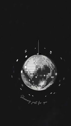 a disco ball with the words something must be you on it in black and white