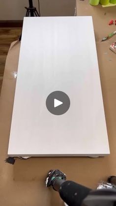 a video demonstrating how to make a paper board with scissors and glue on the table