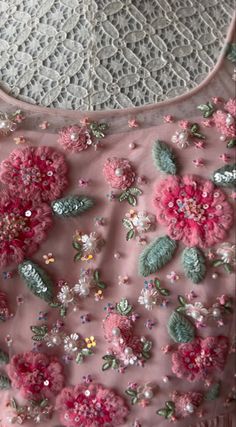 a pink top with flowers and sequins on it